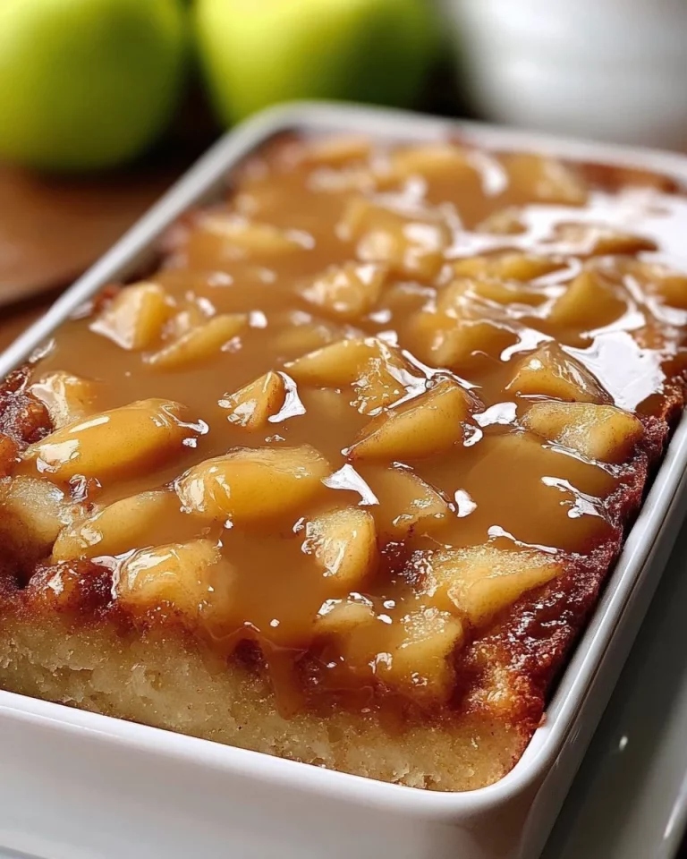 Delicious homemade Apple Dapple Cake topped with nuts and caramel glaze.