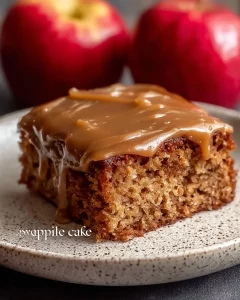 Delicious homemade apple spice cake topped with cinnamon and fresh apples.