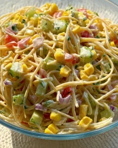 A bowl of colorful Confetti Salad featuring fresh vegetables and herbs