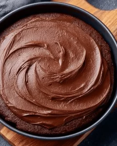 Delicious Eggless Tawa Chocolate Cake served on a plate with chocolate drizzle.