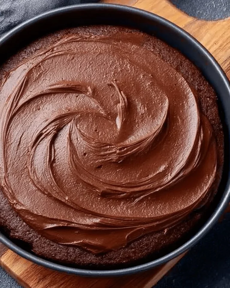 Delicious Eggless Tawa Chocolate Cake served on a plate with chocolate drizzle.