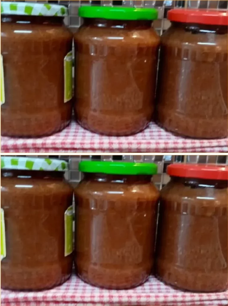 Jar of homemade apple jam with fresh apples and spreader