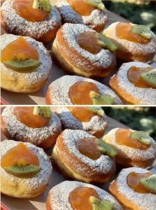 Delicious homemade yeast donuts filled with jam on a plate