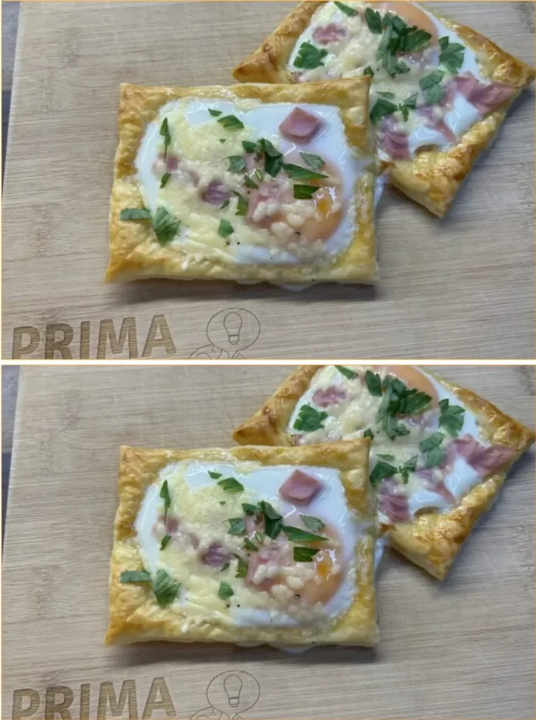 Puff pastry breakfast rolls filled with egg, ham, and cheese on a baking tray