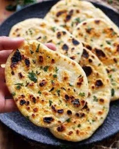 Homemade gluten-free naan bread made with 6 vegan ingredients on a wooden board