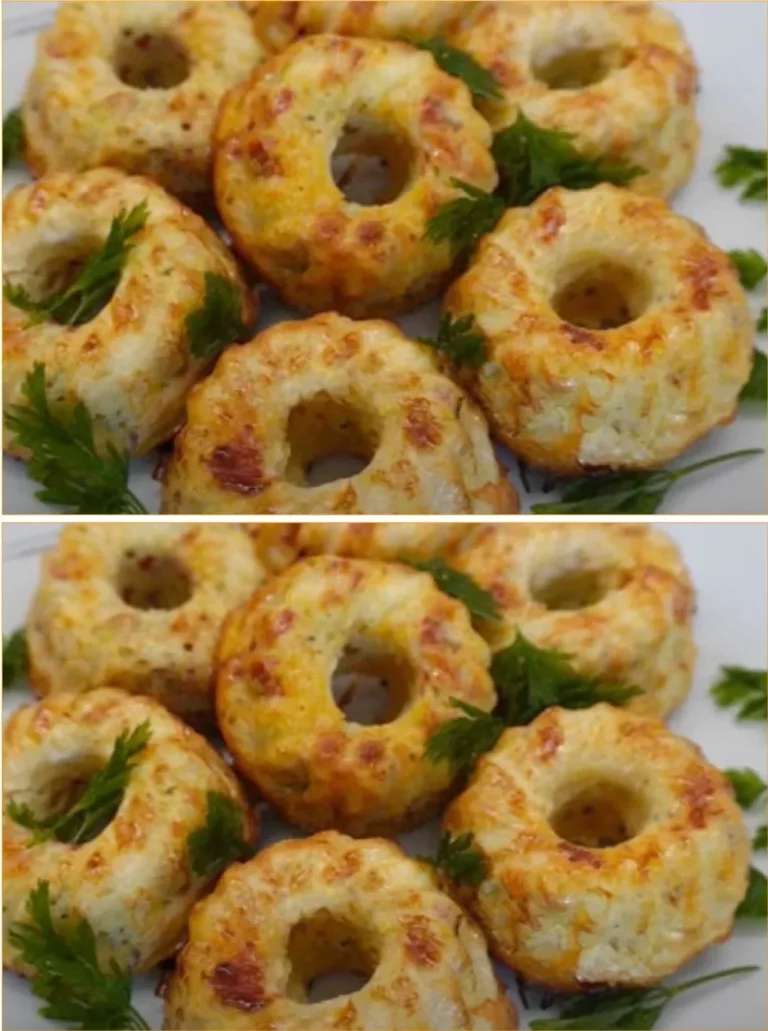 Zucchini and potato pancakes stacked on a plate, garnished with herbs.
