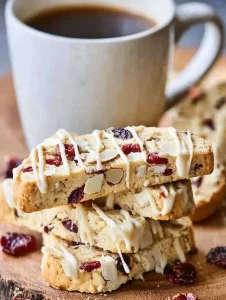 Homemade almond biscotti with dried red blueberries on a wooden table
