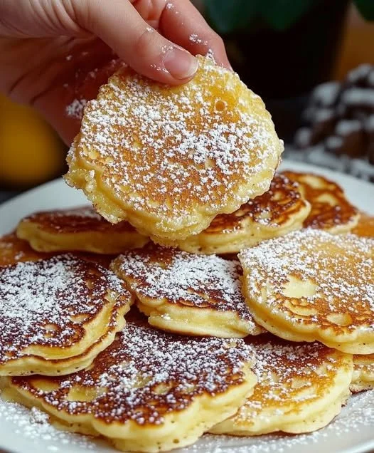 Fluffy apple yogurt pancakes stacked on a plate with syrup