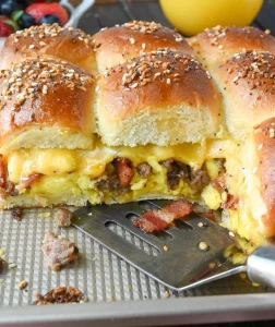 Delicious homemade breakfast sliders with eggs, cheese, and bacon on soft buns