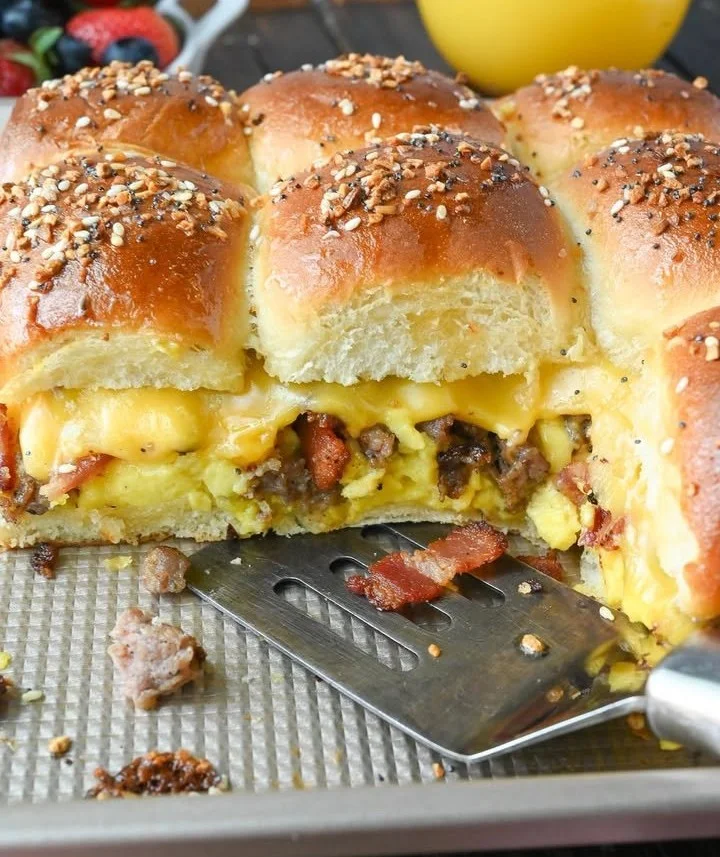 Delicious homemade breakfast sliders with eggs, cheese, and bacon on soft buns