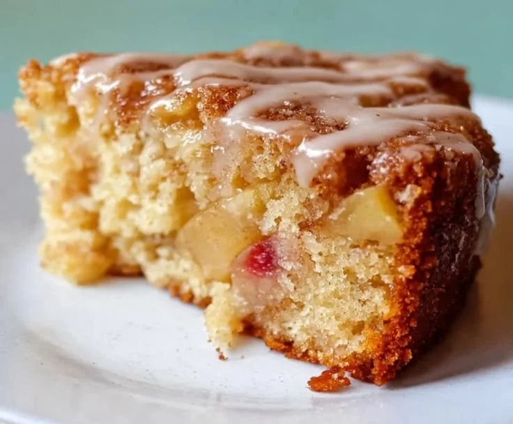 Deliciously moist cinnamon apple cake topped with fresh apple slices and cinnamon.