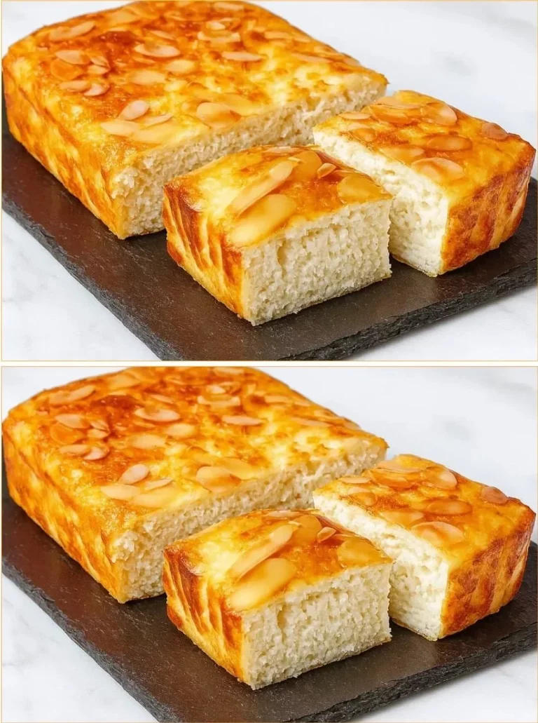 Deliciously fluffy Coconut Cloud Cake topped with coconut flakes.