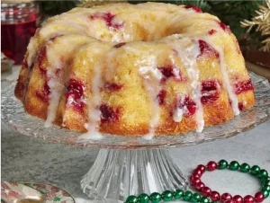 Delicious Cranberry Orange Bundt Cake adorned with cranberries and orange zest.