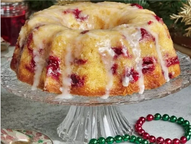 Delicious Cranberry Orange Bundt Cake adorned with cranberries and orange zest.