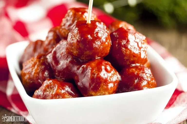 Cranberry slow cooker meatballs served in a dish with garnish