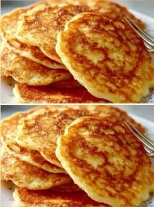 Plate of crispy potato pancakes garnished with sour cream and chives