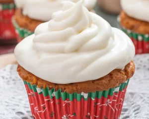 Small batch carrot cake cupcakes with cream cheese frosting on a dessert table.