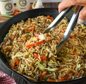 Savory ground beef with ramen noodles in a bowl, ideal for a quick meal.