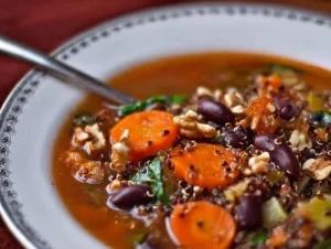 A bowl of hearty holiday soup filled with vegetables and spices for festive comfort.