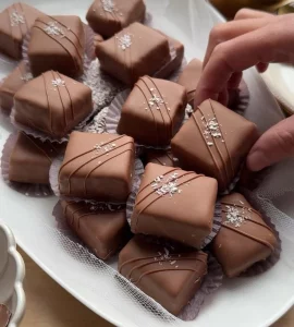 No-bake chocolate coconut bites stacked on a plate, perfect for a healthy treat.
