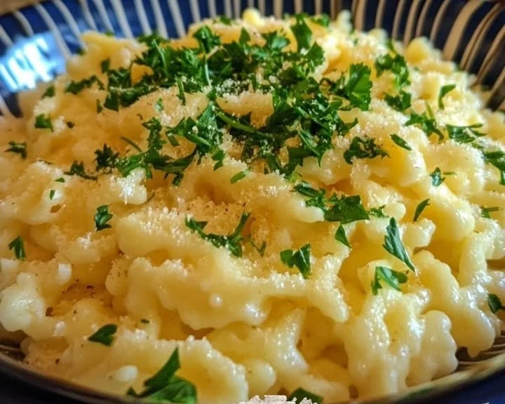 A bowl of steaming noodles garnished with fresh vegetables and herbs.