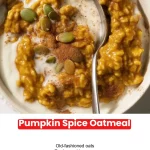 Warm bowl of pumpkin spice oatmeal topped with cinnamon and nuts