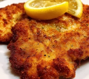 Delicious Viennese Schnitzel served with lemon and parsley garnish.
