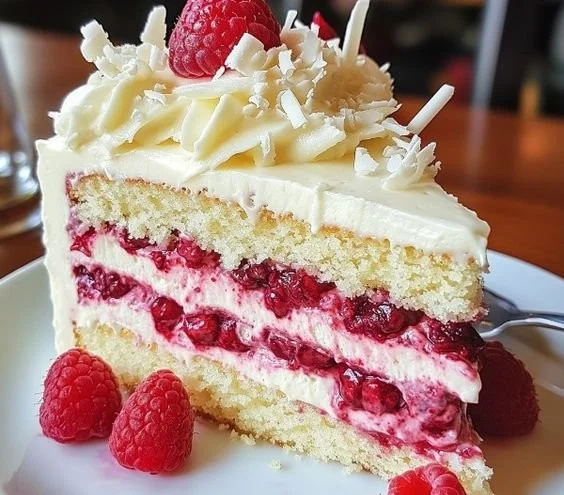 White Chocolate Raspberry Dream Cake with fresh raspberries and white chocolate drizzle