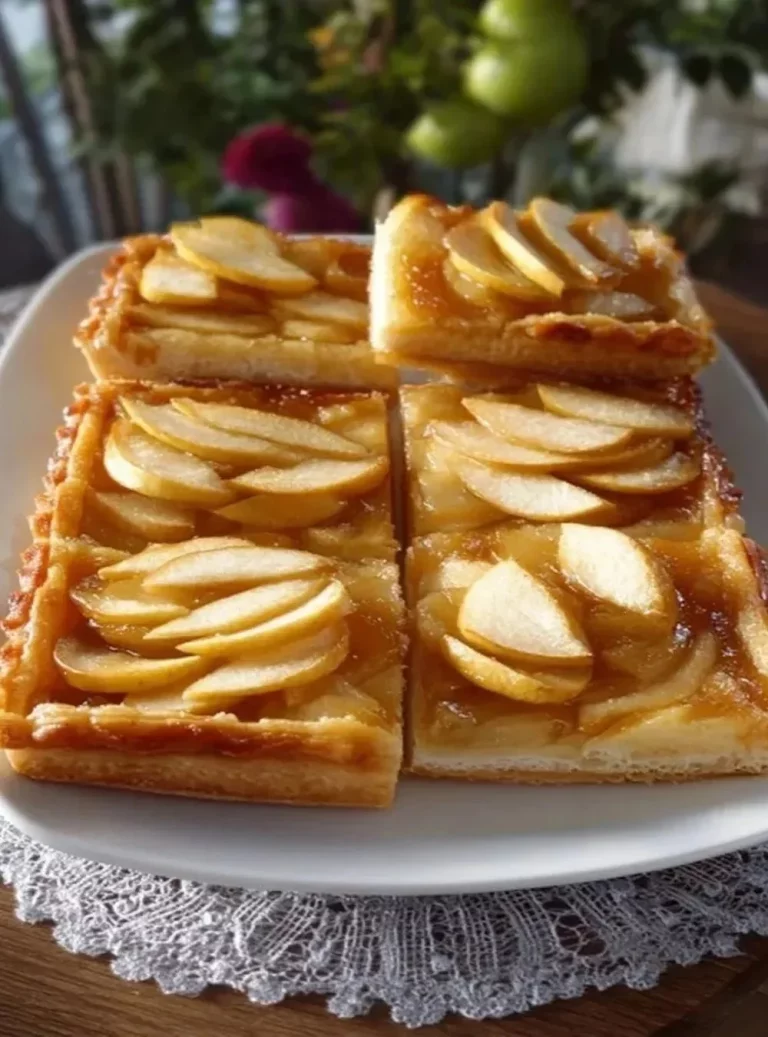 Apple dessert made with puff pastry, featuring baked apples and flaky crust.