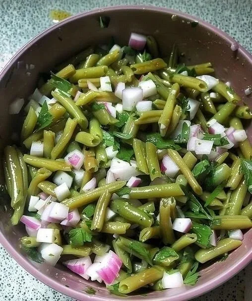 Delicious bean salad with two types of onions, garnished and ready to serve.