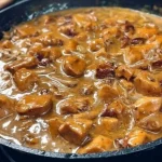 Chicken breasts cooked with mushrooms and onions for a delicious meal.