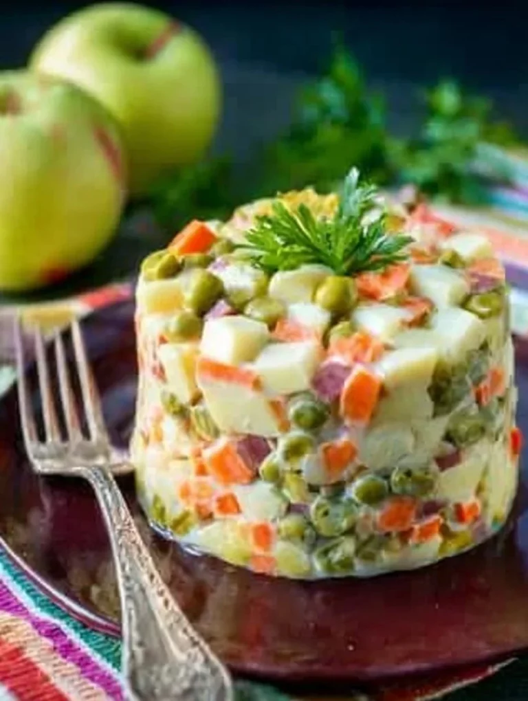 Classic Winter Salad Olivier with Sausage and Apple on a festive table