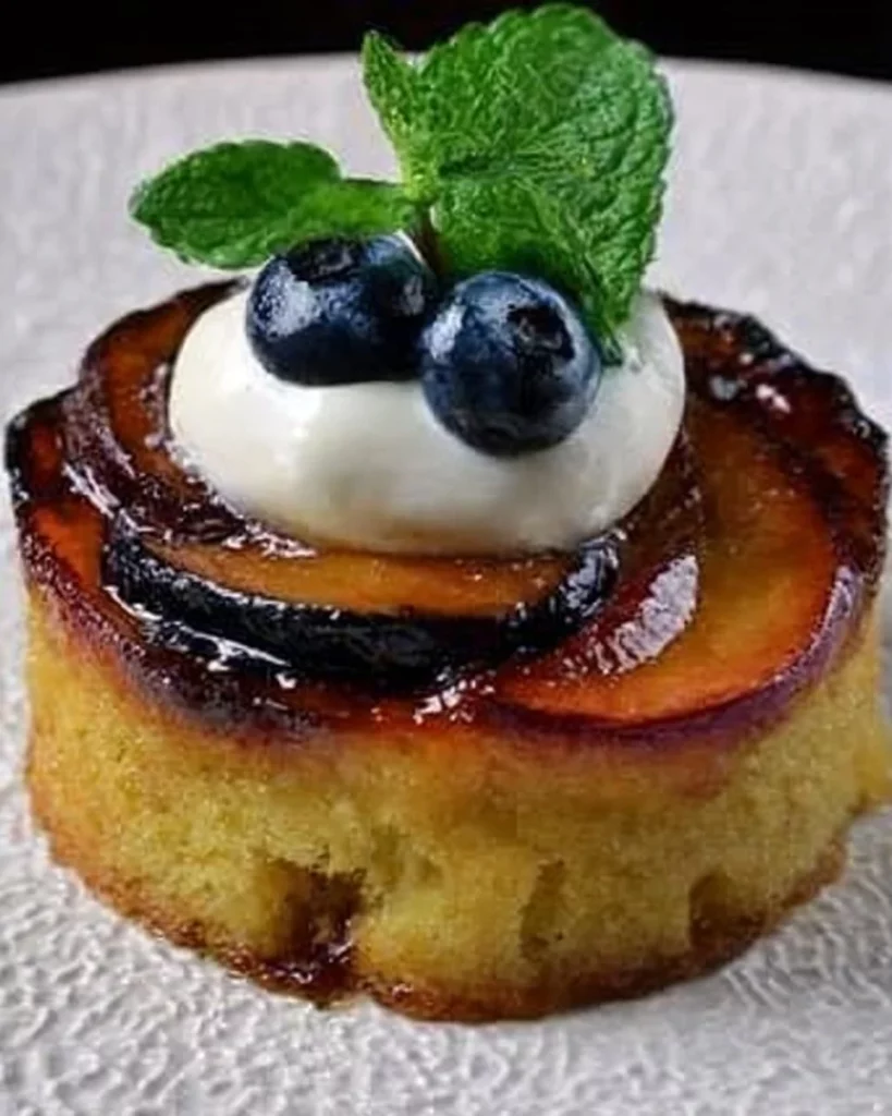 Gluten-free Doughnut Peach Almond Cake topped with fresh peaches and almonds.