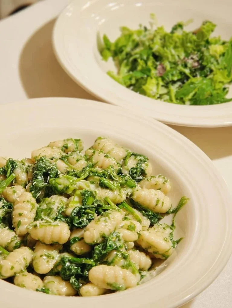 Plate of homemade Sardinian Gnocchi Malloreddus with sauce and herbs