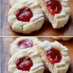 Close-up of Raspberry Thumbprint Cookies with raspberry jam filling