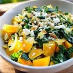 Warm Golden Beet Salad with Greens and Almonds served in a bowl