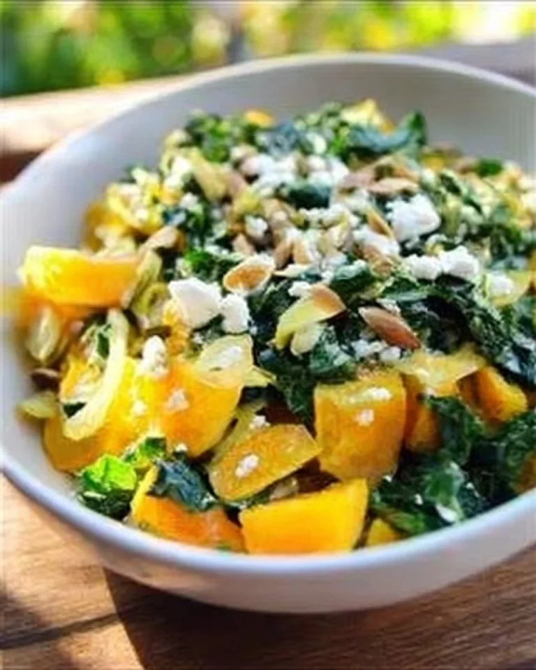 Warm Golden Beet Salad with Greens and Almonds served in a bowl