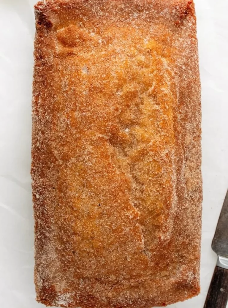 Slice of cinnamon sugar donut bread topped with sugar and cinnamon