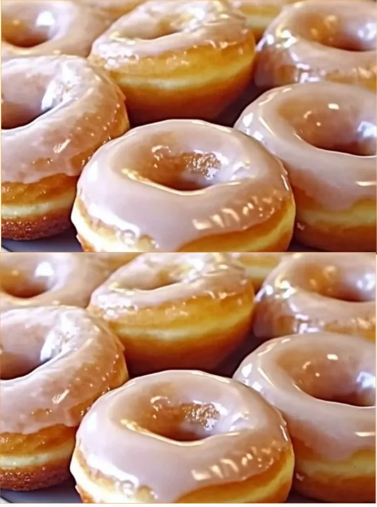 Freshly made homemade glazed doughnuts on a wooden table