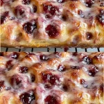 Freshly baked jam donut focaccia with fruity jam filling and golden crust.
