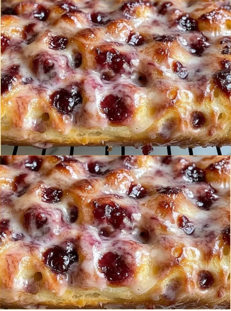 Freshly baked jam donut focaccia with fruity jam filling and golden crust.