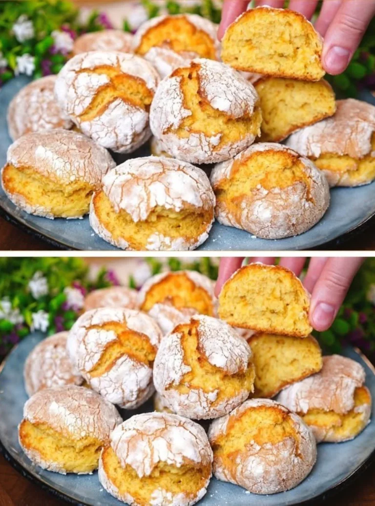Freshly baked orange cookies with citrus glaze on a cooling rack.