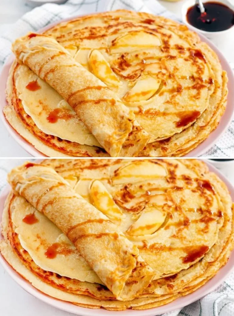 Fluffy pancakes stacked on a plate with syrup and berries